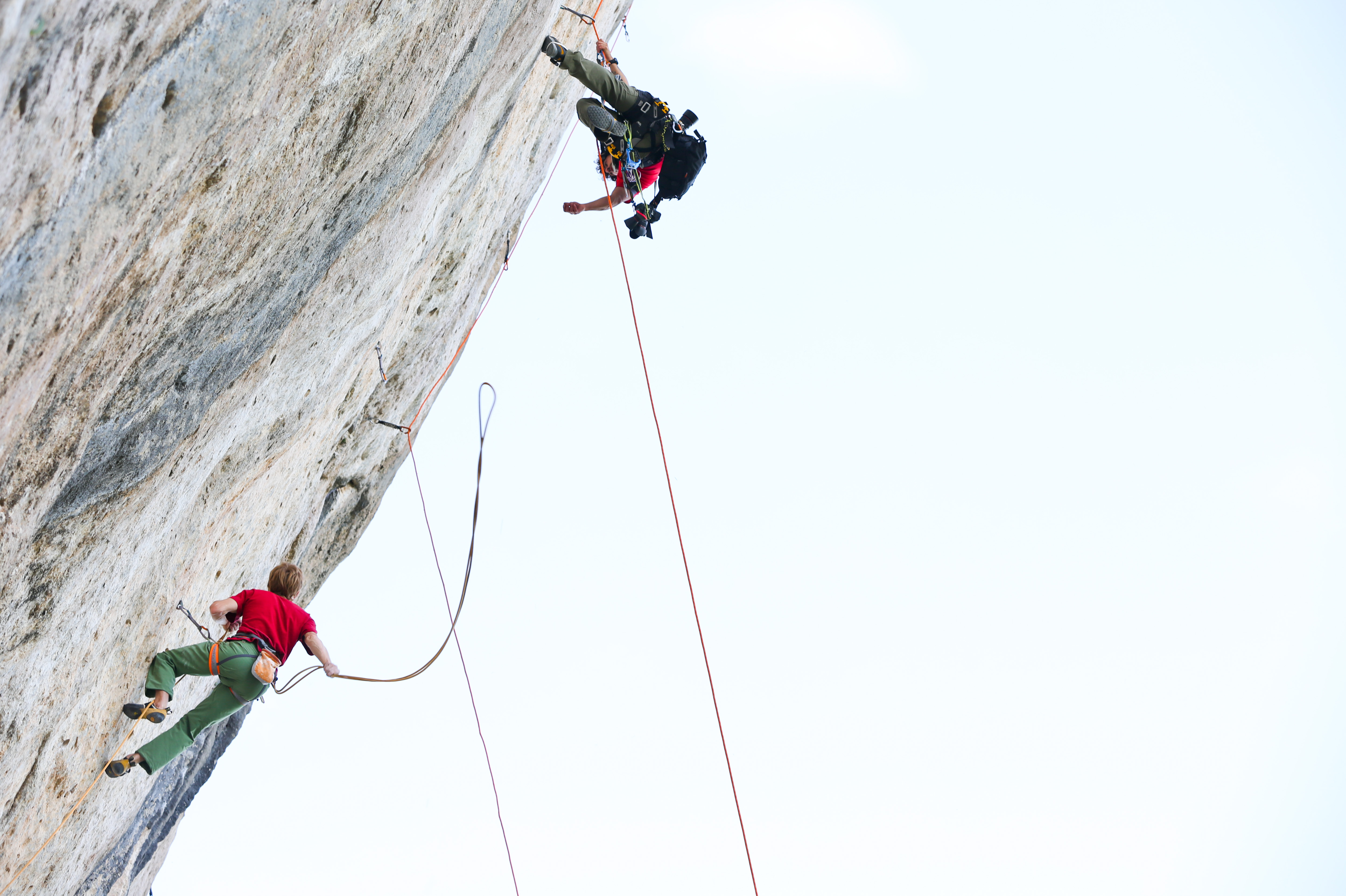 Arnaud Petit helps with some rigging during a video shoot at his home crag in Ceuse, France,